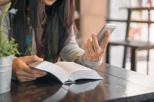 Woman reading and checking phone